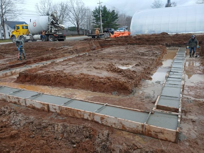 Freshly poured concrete footings formed up on a prepared building site