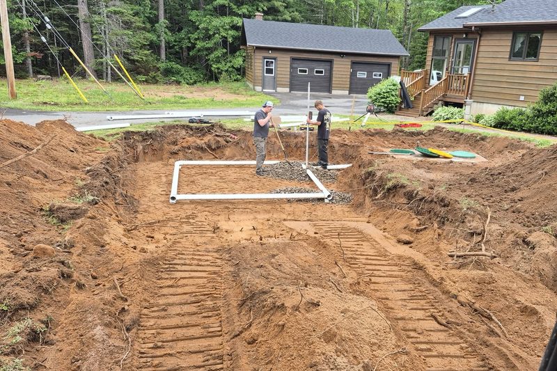 Septic bed under construction with piping laid out in a fresh excavation